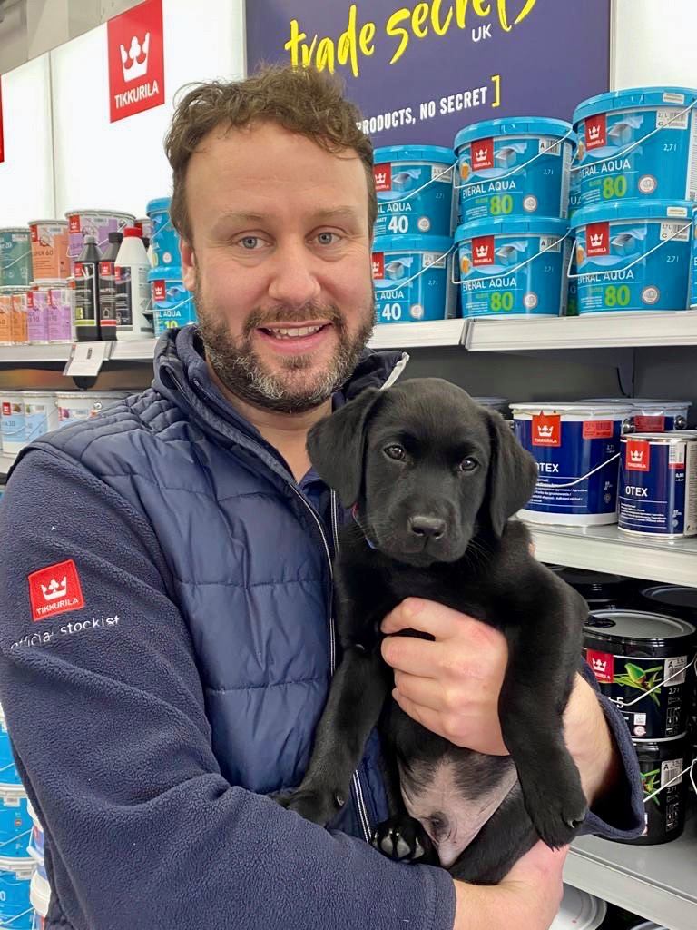 Scott and his new puppy, Dexter, in front of Paint Tubs at Trade Secrets